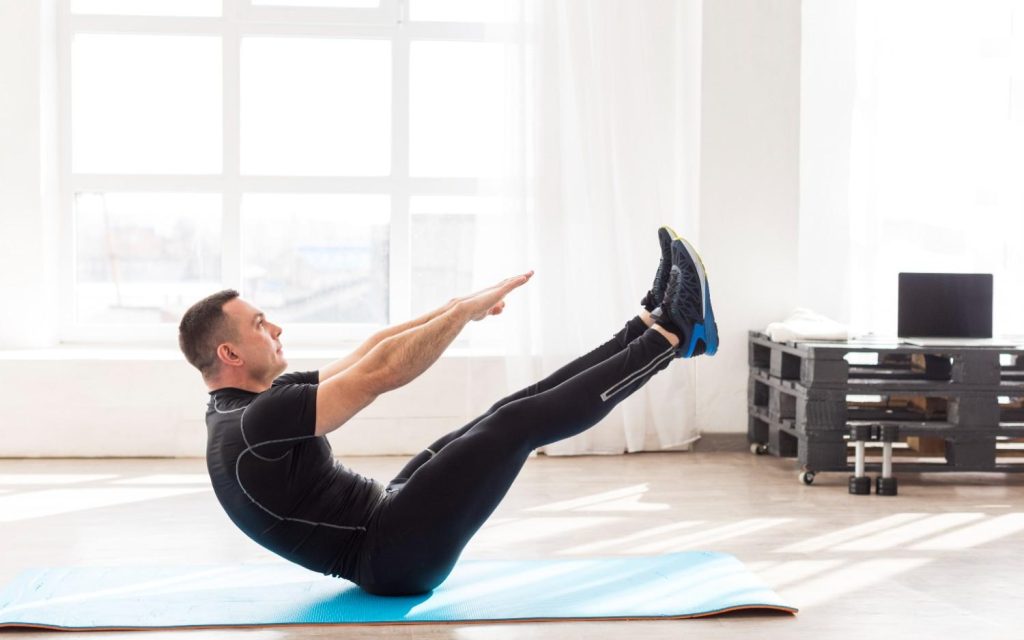Man performing lower ab workout exercise at home