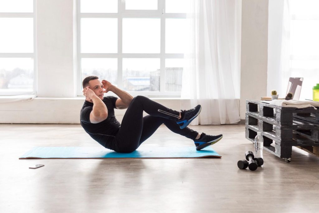 Man doing lower ab exercises on a workout mat