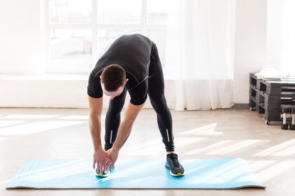 Man performing an upper back mobility stretch at home